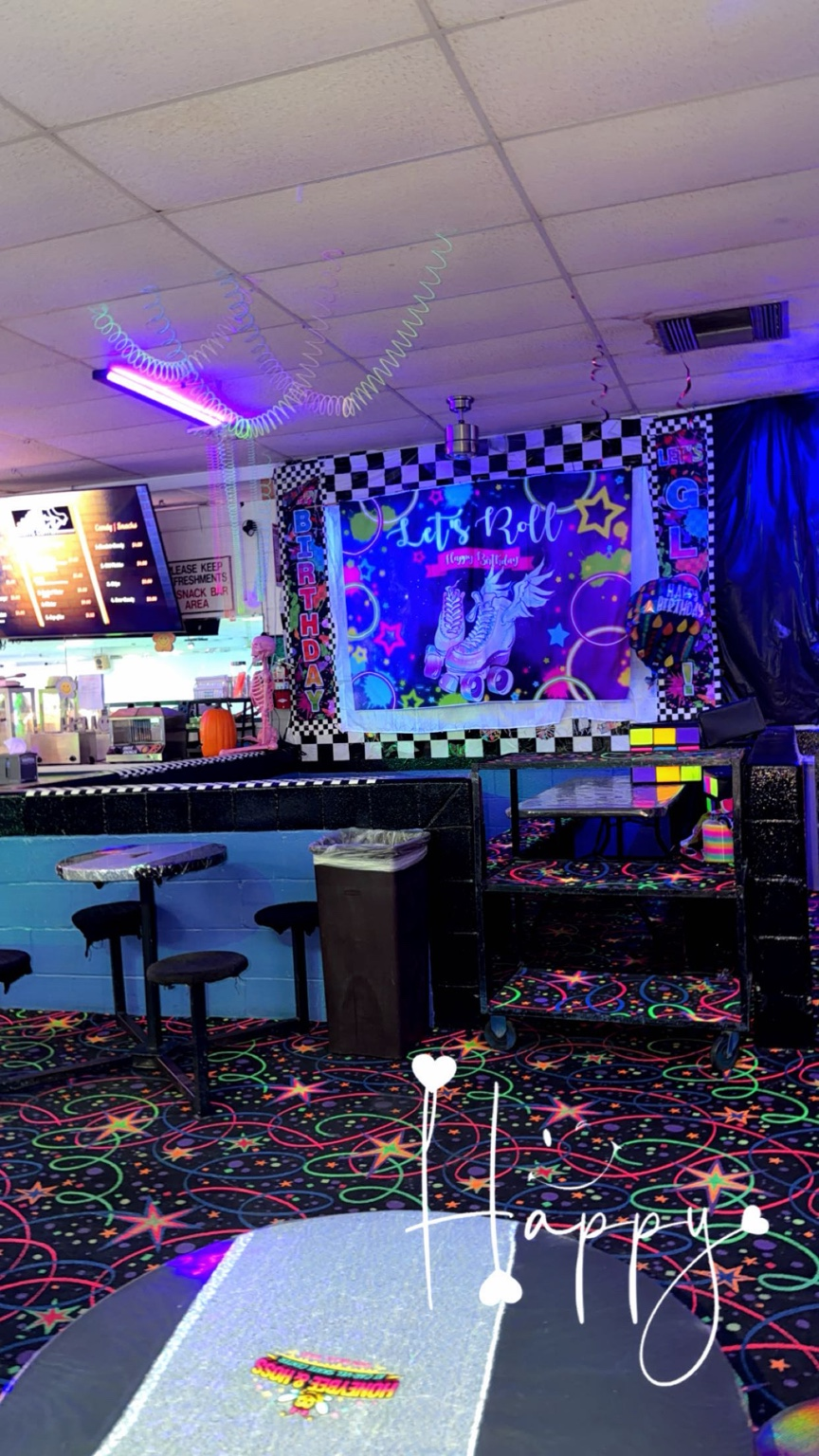 Checkered Glow party area with Let's Roll backdrop